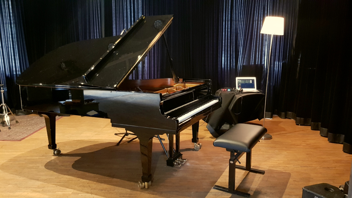 piano Steinway B211, recording setup, on stage but with the piano turned towards the curtains for acoustic reasons.